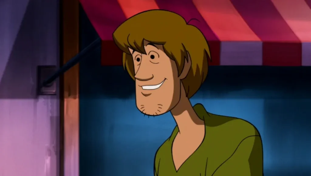室内で気まずそうに笑う Shaggy